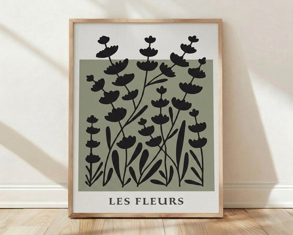 Minimalist botanical poster with sage green flowers and black stems on off-white background, framed on wall in serene japandi style.