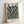 Zen garden inspired wall art with delicate plant stems and leaves in muted sage and black tones, minimalist japandi design.