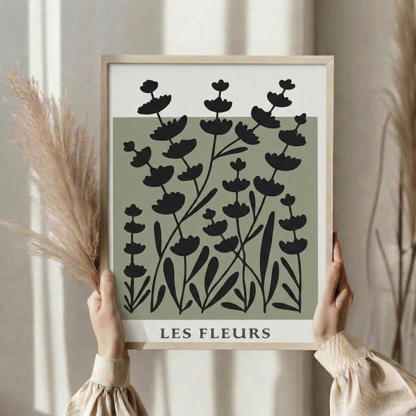 Contemporary botanical art print in soft sage green and black ink, understated japandi design on neutral canvas for wall display.