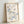 Contemporary line art print showing elegant butterfly and flower motifs in navy blue and warm brown on cream, embodying minimalist wabi sabi style.