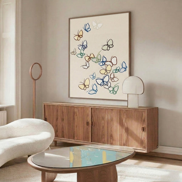 Delicate line art framed print depicting butterflies and blooms in muted palette of cream, navy, sage, and pale yellow with a peaceful, understated mood.