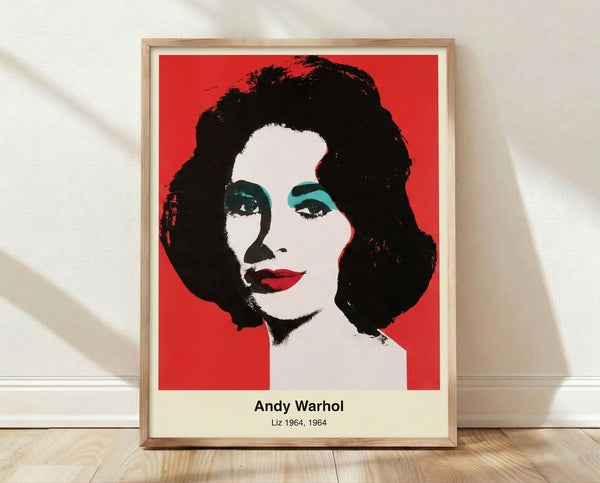 Pop art portrait of a woman's face in vibrant magenta, cyan, and yellow tones with bold black outlines, framed poster on wall.