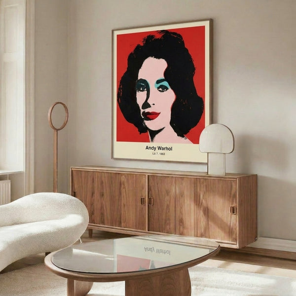 Framed contemporary pop art showing a woman's visage in hot pink, cyan, and golden yellow with high-contrast graphic elements in the pop art tradition.