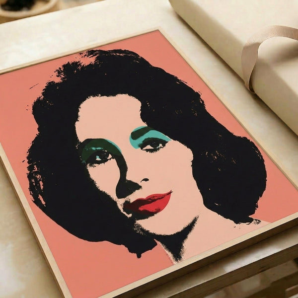 Framed Elizabeth Taylor pop art portrait rendered in fluorescent pinks, blues, and yellows with silkscreen-style graphic treatment and expressive color blocking.