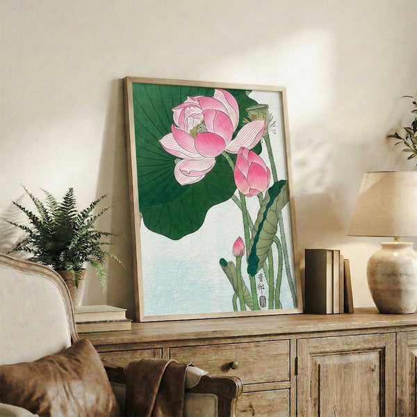Contemplative botanical art print showing a lotus flower in pale pink with layered green leaves, rendered in traditional Japanese woodblock style with elegant line work.