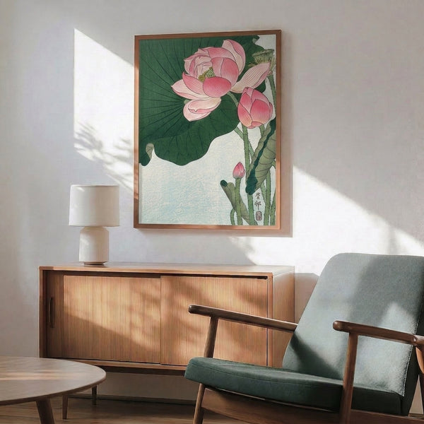 Elegant floral wall art featuring an Asian botanical study of a pink lotus flower with detailed leaves and stems in muted greens and cream hues, presented as a framed print.