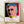 Pop art portrait of Louis Brandeis in Warhol style, featuring bold black lines and vibrant red and cream tones on a grey background, framed on a wall.