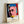 Modern pop art framed poster depicting a cultural figure in Warhol's signature style, with bold graphic elements in cream, red, and charcoal grey.