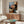 Modern poster art displaying a contemplative figure holding a steaming cup of coffee, created with simplified forms and earthy tones in Matisse's decorative style.