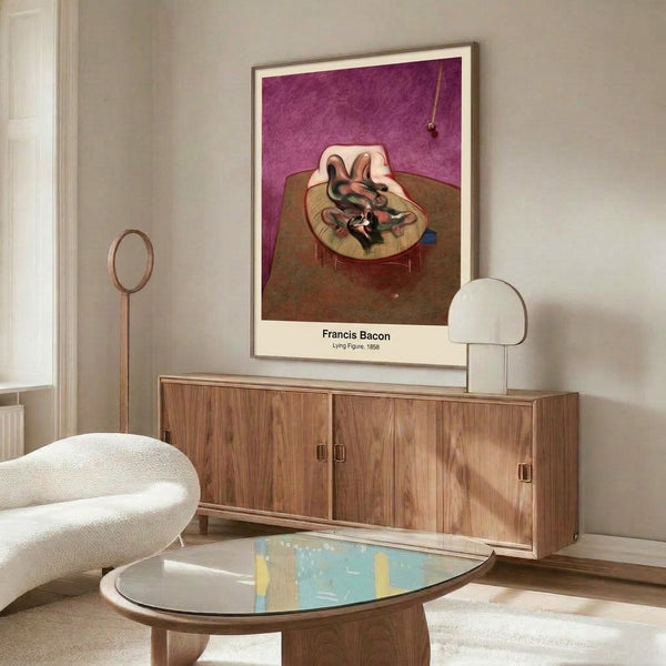 Framed abstract artwork portraying a twisted prone figure in creams and burgundy, suggesting vulnerability and psychological complexity through fragmented form.