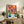 Cut-out style abstract portrait combining warm coral and cool blue tones with ochre accents, a framed minimalist wall print.