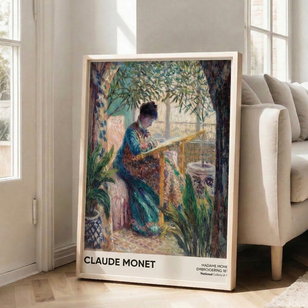 Framed impressionist artwork capturing quiet domestic life—a woman embroidering in filtered daylight, with delicate handling of cream, pale yellow, and cool blue hues.