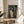 Wall-mounted art print of an iconic spiritual portrait with glowing halo, painted in moody expressionist colors ranging from burnt sienna to pale gold.