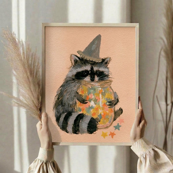 Charming framed poster featuring a magical raccoon in a witch hat clutching a star-filled jar, rendered in soft watercolor tones of gray, black, and gold.