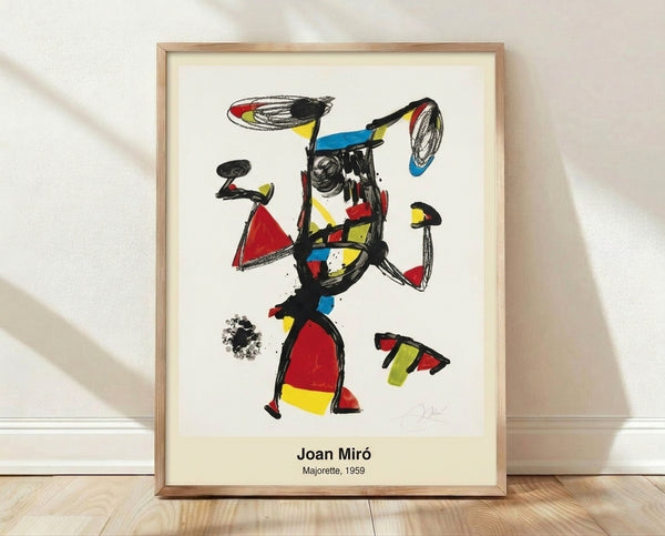 Abstract modernist poster featuring a stylized figure in black, red, blue, and yellow geometric forms suggesting a dynamic dancing or jumping pose, framed on a wall as a contemporary art print.