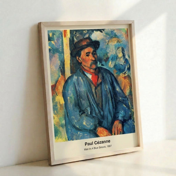 Framed modern portrait artwork depicting a seated man in a blue smock, executed in soft impressionist style with warm and cool earth-tone palette.