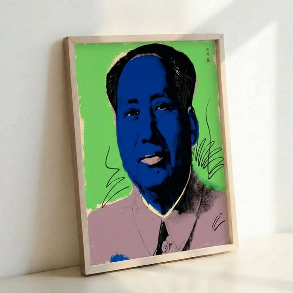 Contemporary pop art interpretation of a figure's face in saturated hues, shown as framed poster in minimalist setting