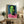 Large-scale portrait poster in electric colors with expressive brushwork and high-impact pop aesthetic on gallery wall.