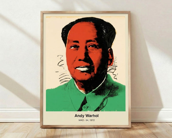 Bold pop art portrait of Mao in vibrant magenta, pink, and yellow with black outlines, framed on wall as modern art print.