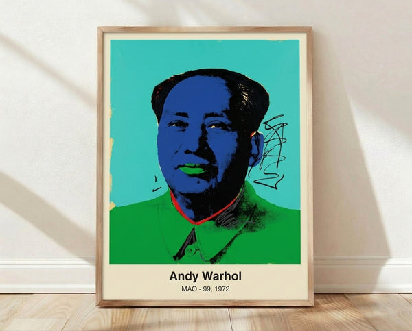 Pop art portrait print with bold, glamorized face rendered in vibrant red, pink, yellow, and turquoise on black background, framed on wall.