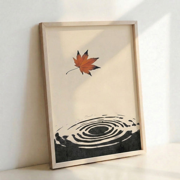 Zen-inspired minimalist poster art with a stylized maple leaf in warm rust-orange, nested inside a bold enso circle with flowing ripple patterns in black and charcoal on a soft cream ground.