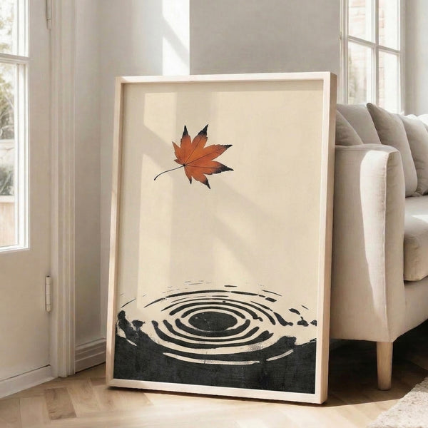 Wabi-sabi wall art print: a single autumn maple leaf framed by concentric ripple lines and an enso circle, hand-drawn in Japanese woodblock style using rust, black, and charcoal on natural cream.