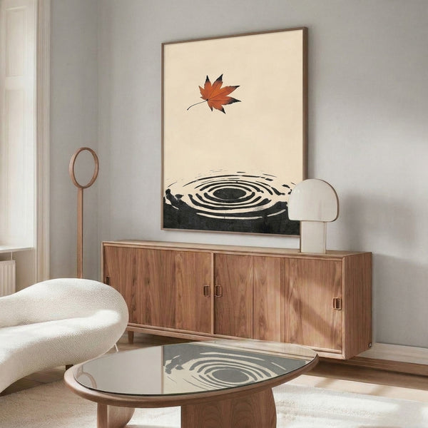 Zen poster art featuring a maple leaf and enso circle with rippling water lines, rendered in a restrained palette of rust-orange, black, and charcoal on cream, echoing Japanese woodblock printmaking traditions.