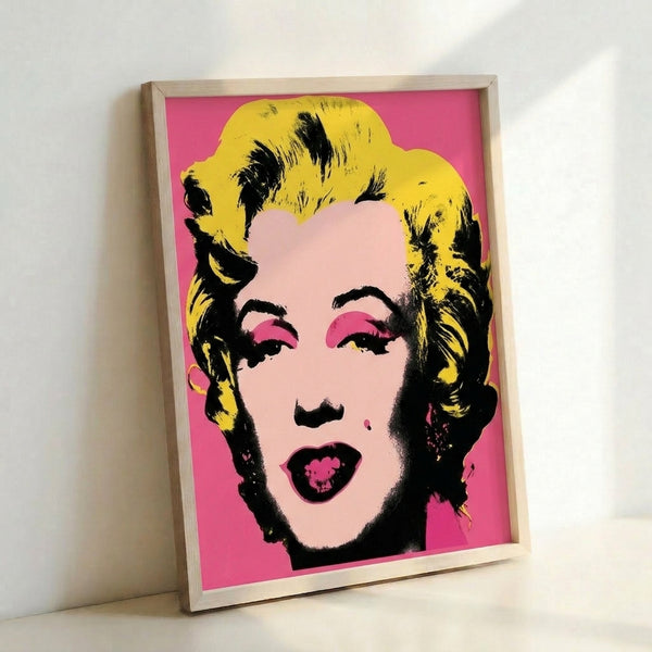 High-contrast pop art print showcasing a graphic portrait in electric colors including hot pink and turquoise, displayed as wall art.