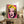 Modern pop art-inspired portrait featuring simplified facial features in striking pink, blue, and yellow palette, framed and displayed on a wall.
