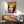 Contemporary pop art print depicting a stylized face in bright layered colors including hot pink and electric blue tones, framed on a wall.