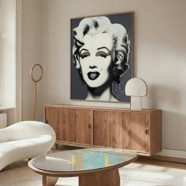 Monochromatic Marilyn Monroe portrait art print with pop art sensibility, featuring stark tonal contrast and minimalist illustrative approach on a wall.