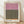 Abstract minimalist poster featuring soft mauve pink and olive green rectangular forms with burnt orange accents on cream background, evoking a contemplative mood.