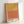 Minimalist poster art with soft coral and golden hues arranged in meditative color blocks, creating a peaceful abstract composition on gallery wall.