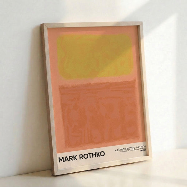 Minimalist poster art with soft coral and golden hues arranged in meditative color blocks, creating a peaceful abstract composition on gallery wall.