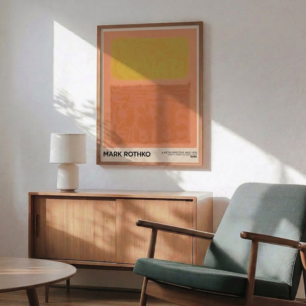 Serene abstract art print framed on wall, displaying soft coral, golden yellow, and warm earth tones in minimalist layered rectangles.