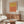 Modern color field poster with coral, burnt sienna, and golden yellow abstract forms creating a contemplative meditative mood.