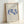 Contemporary framed poster with contemplative dancing nudes drawn in minimalist cobalt blue strokes against a cream base.