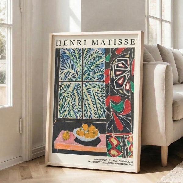 Framed minimalist interior art showing a window with patterned curtain, flourishing ferns, golden fruit study, and refined decorative elements in muted cream and jewel tones.
