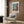 Wall art print of a serene domestic scene featuring ornate curtains, botanical details, and a still life composition in modern minimalist style with cream, blue, green, and gold.