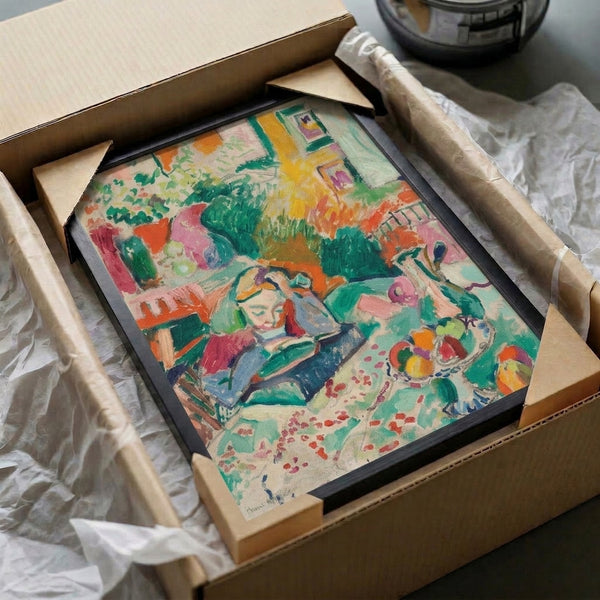 Colorful framed interior scene poster featuring a young girl surrounded by table décor, flowers, and natural light; combines Art Nouveau sensibility with bold coral, emerald, and yellow tones.