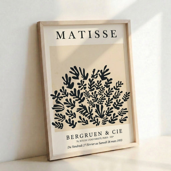 Cream-colored poster with organic seaweed and plant silhouettes in charcoal, mid-century modern design evoking Matisse's elegant paper cutouts.