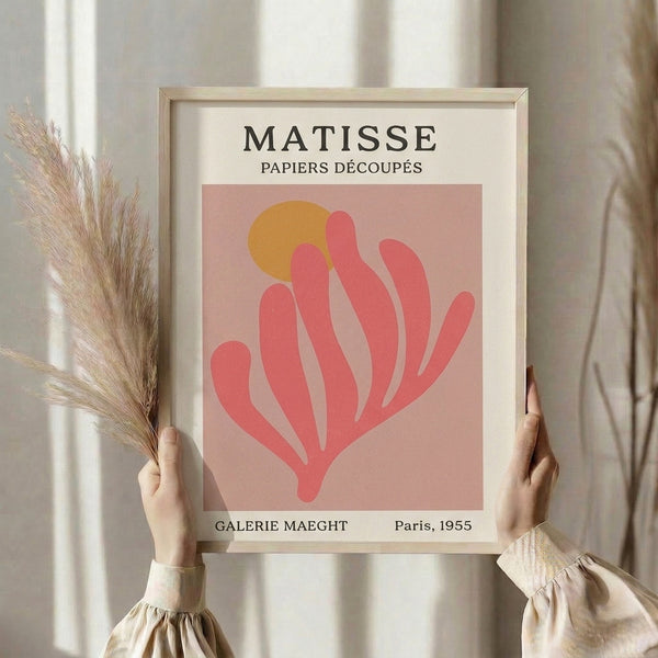 Framed mid-century modern art print showing organic plant shape in soft rose and golden tones, serene and refined.