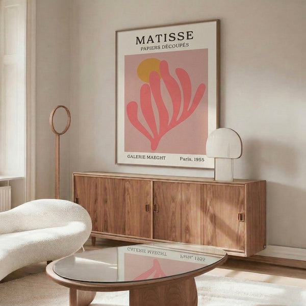 Framed minimalist poster featuring curved plant shape in warm blush and gold, serene mid-century design.