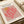 Abstract botanical wall print in soft pink and ochre tones on cream, displaying elegant mid-century modern paper cut aesthetic.