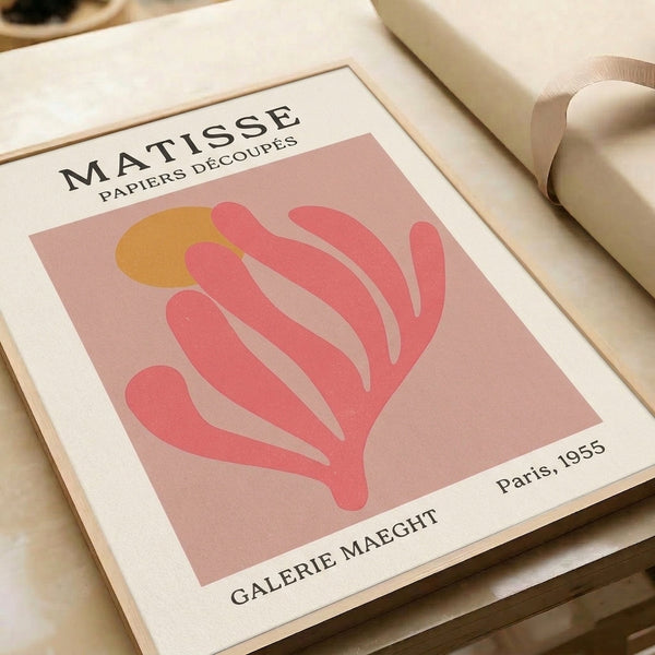 Abstract botanical wall print in soft pink and ochre tones on cream, displaying elegant mid-century modern paper cut aesthetic.