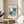 Vintage-style abstract poster featuring stylized bird and moon elements in soft dusty blue and cream tones, ideal for contemporary minimalist interiors.