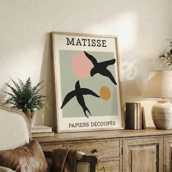 Contemporary art print reinterpreting Matisse's cut-paper approach with abstract bird motifs in sophisticated sage green, cream, and accent colors; minimalist design.