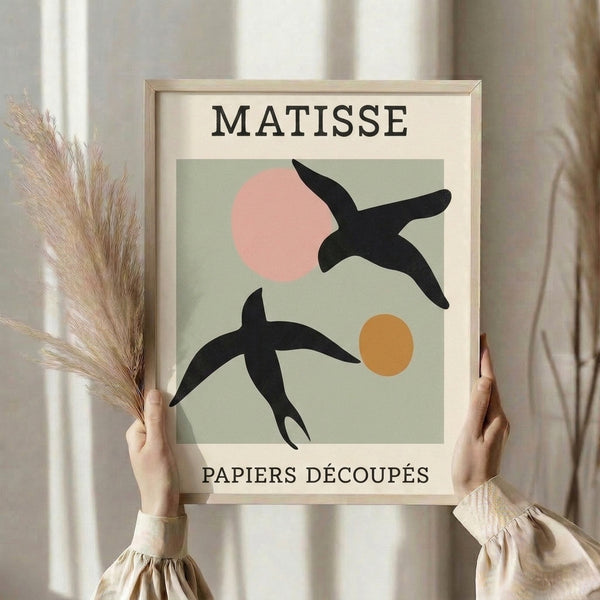Mid-century modern bird art print employing bold paper-cut aesthetic with playful composition of circles and organic forms in muted sage, cream, and pink hues.