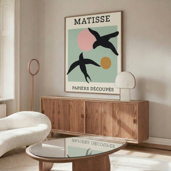 Abstract birds rendered as overlapping paper-cut forms in minimalist palette of sage green, blush, and cream with ochre accents; mid-century modern aesthetic.