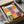 Modern playful poster in jewel tones of chartreuse, dusty rose, sky blue, and coral, showcasing an exuberant arrangement of abstract botanical shapes inspired by Matisse's cut-paper method.